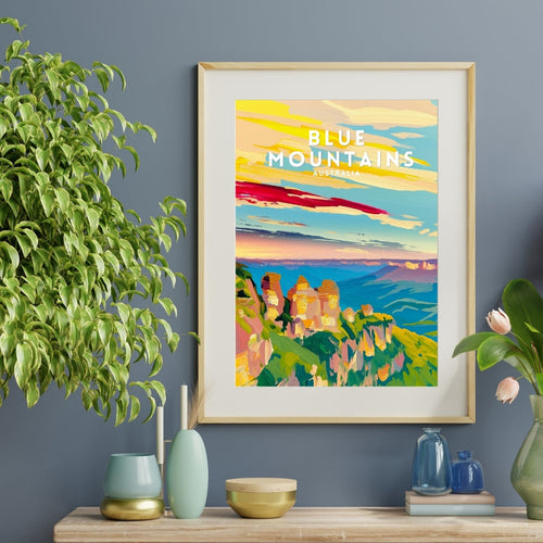 Framed artwork of the Blue Mountains on a wall above a wooden console table with decorative items.