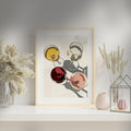 Framed abstract art of wine glasses on a wall with decorative vases and plants.