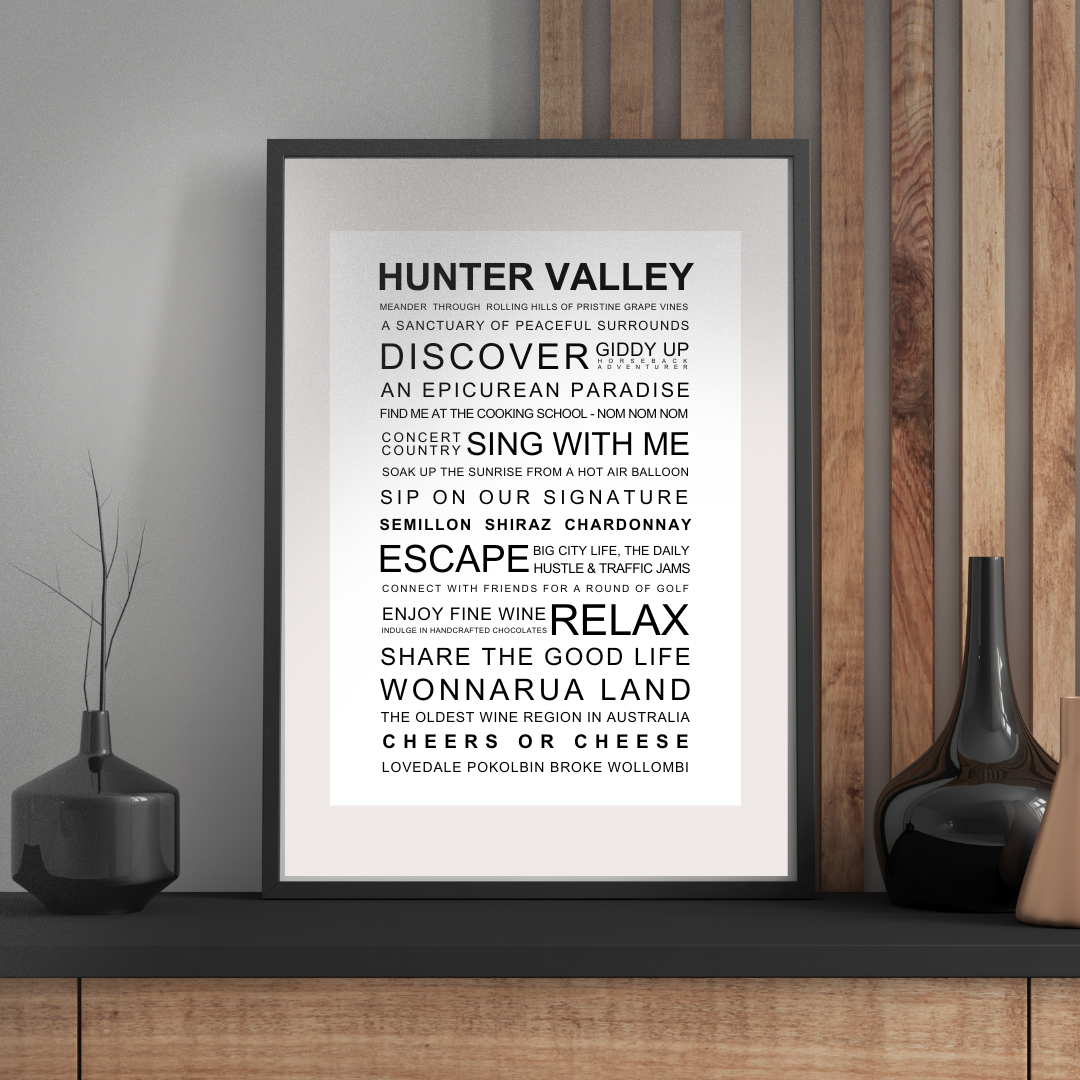 Framed poster with text about Hunter Valley on a wall with decorative vases.