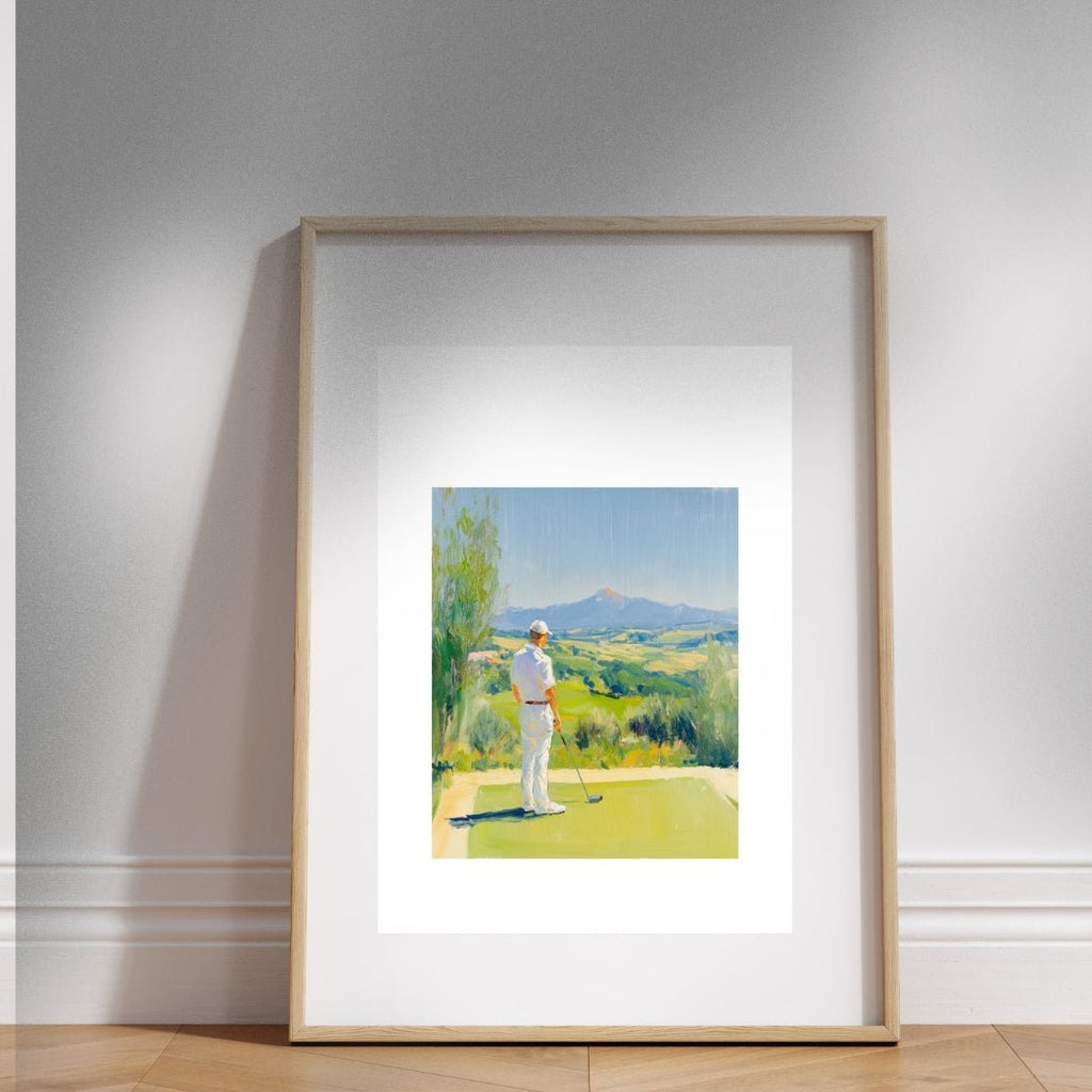 Framed artwork of a golfer on a golf course with mountains in the background, displayed on a wall.