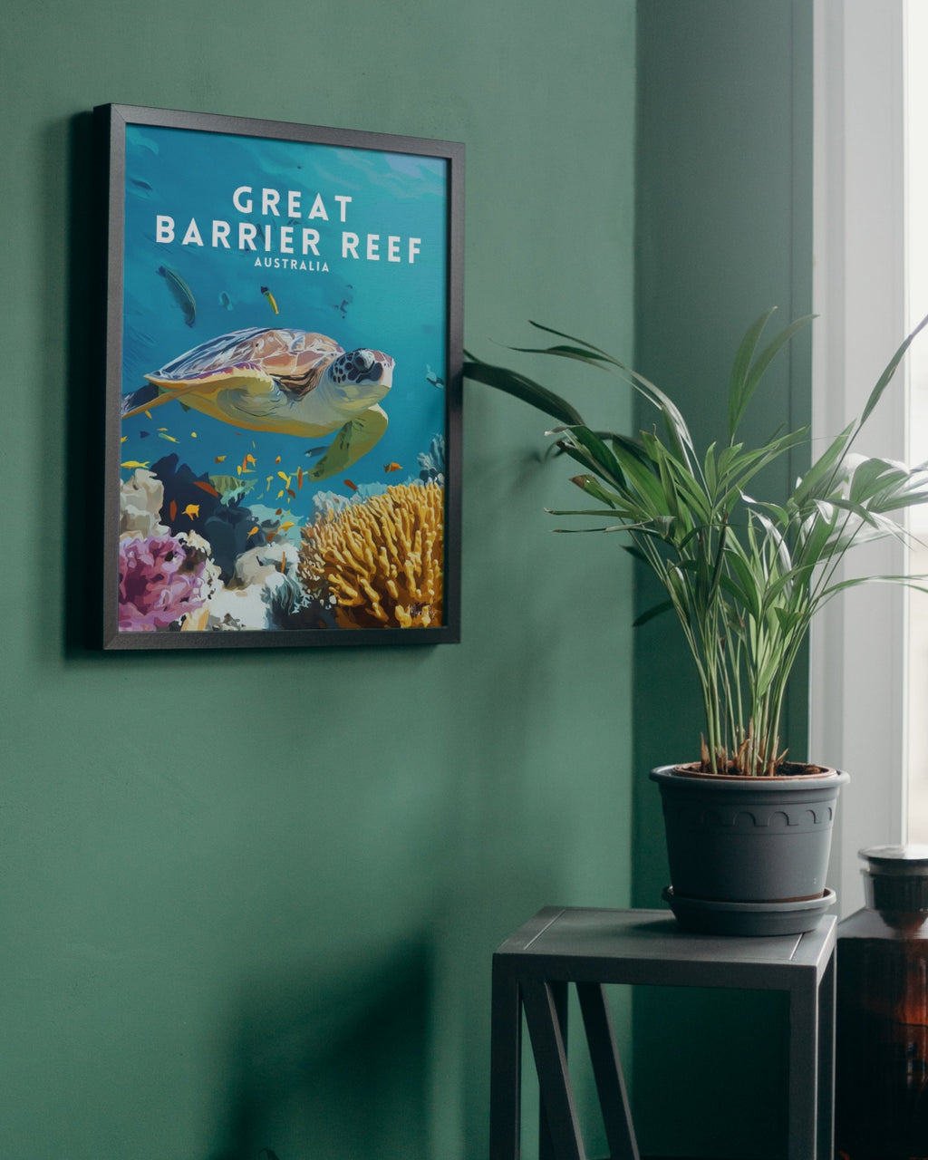 Framed poster of the Great Barrier Reef with a turtle on a green wall.