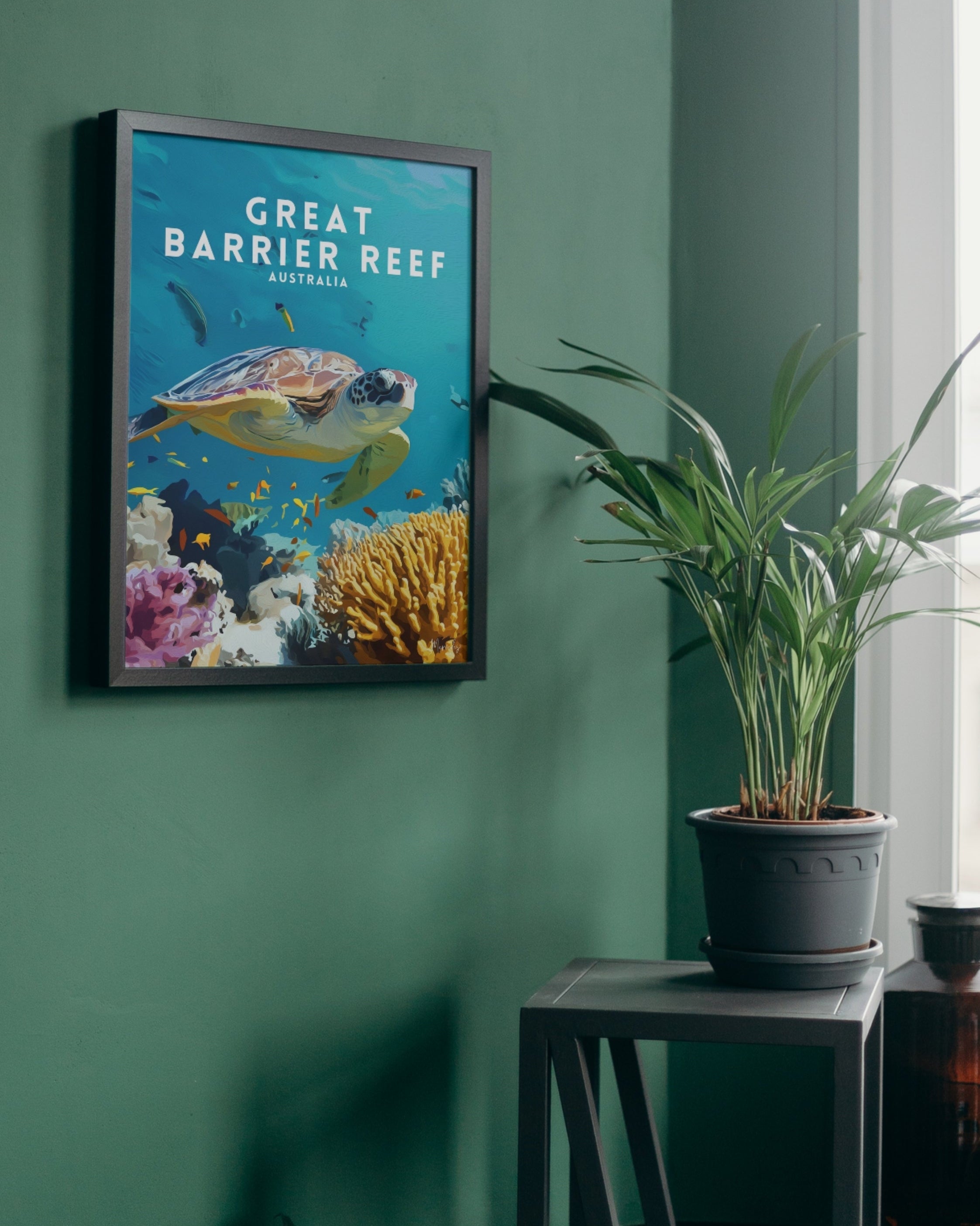 Framed poster of the Great Barrier Reef with a turtle on a green wall.