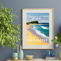 Framed artwork of Nobby's Beach on a wall above a wooden console table with decorative items.