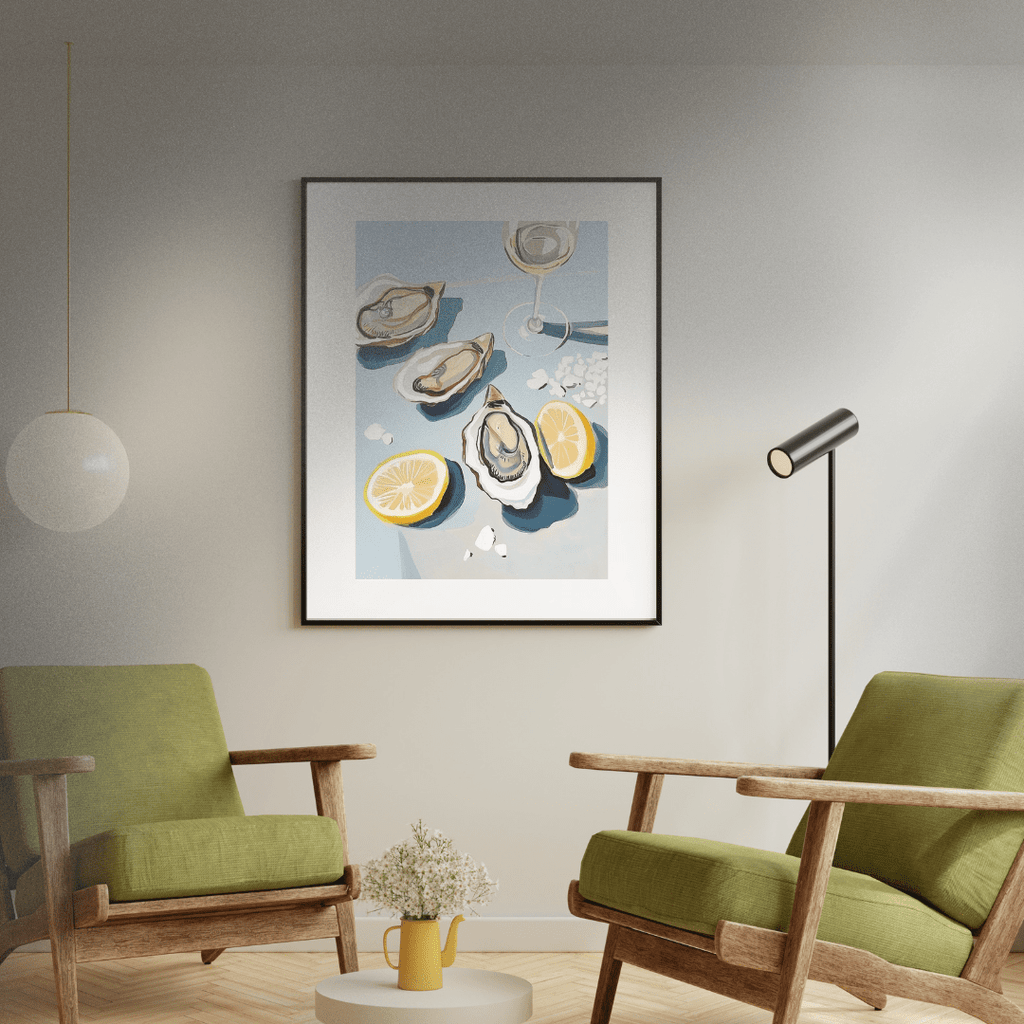 Modern living room with green chairs, a small table, and a framed artwork of oysters, salt and lemon.