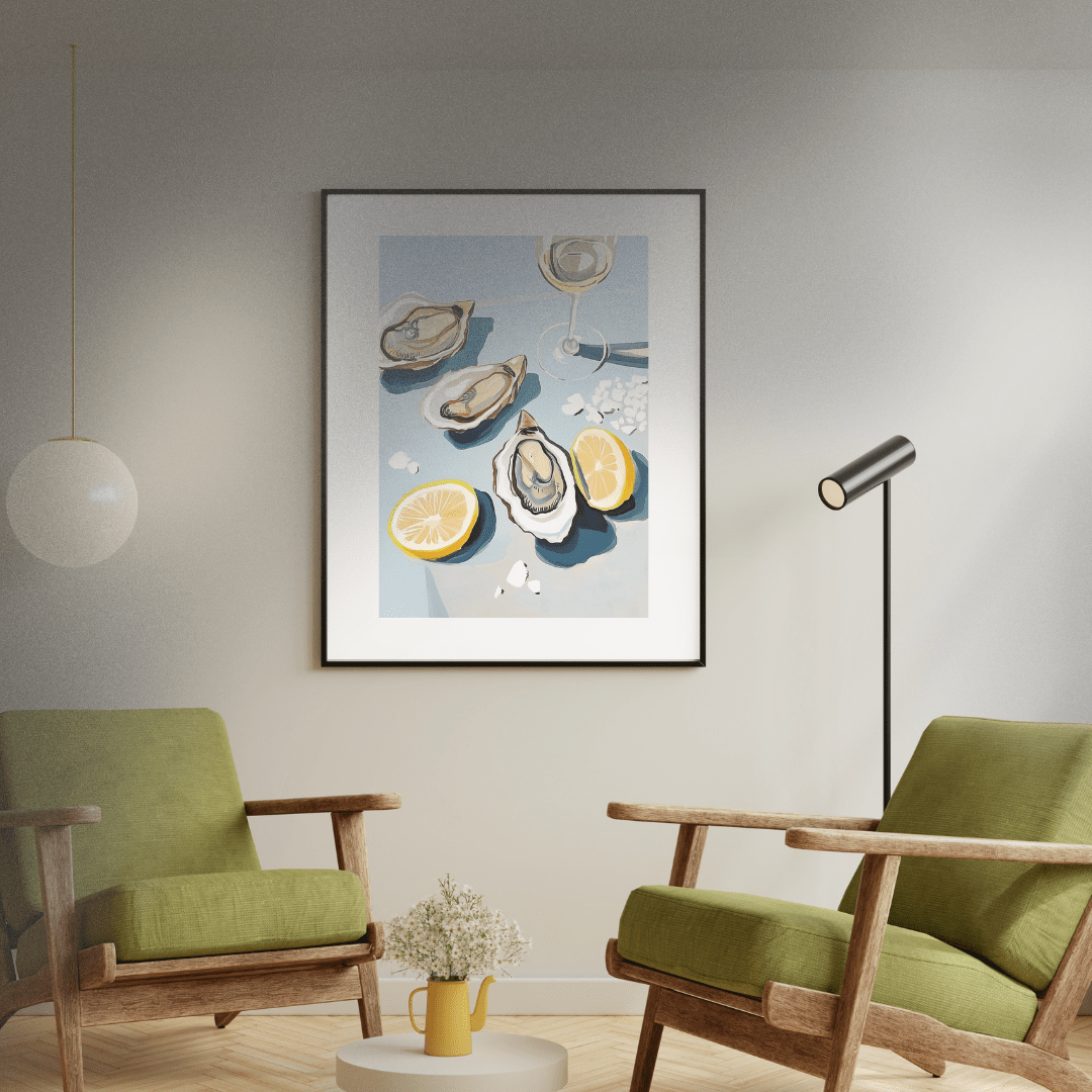 Modern living room with green chairs, a small table, and a framed artwork of oysters, salt and lemon.
