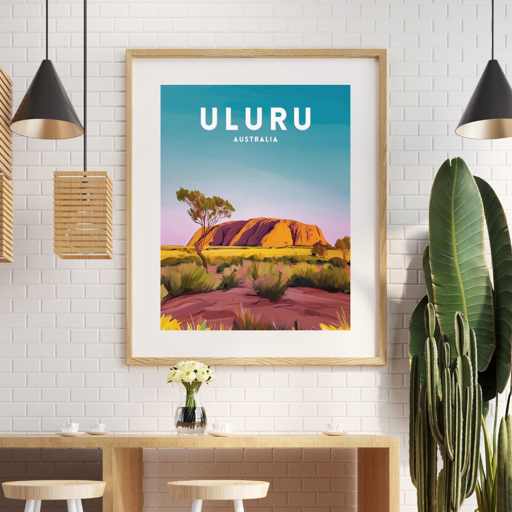 Framed Uluru poster on a wall above a dining table with stools.